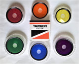 TAMRON COLOR SPOT : E' un filtro di vetro colorato con un foro centrale .Disponibili 49 - 52 - 58mm.